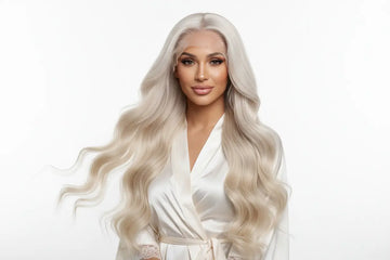 A woman with long platinum blonde body wave hair wearing a white satin robe for human hair wig and closure wig guide