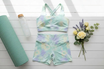 Pastel tie-dye athletic two-piece set with moisture-wicking fabric featuring high-waist leggings in mint green lavender and pale yellow