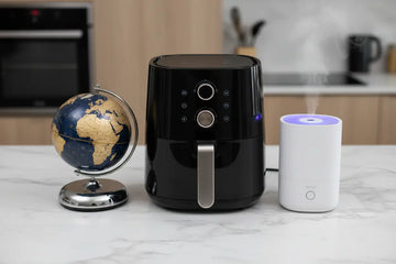 Black air fryer with silver handle and control buttons featured in smarter kitchen appliances for 2026.