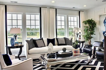 White sofa with black and white patterned throw pillows from royalessencelux home fabric accessories collection