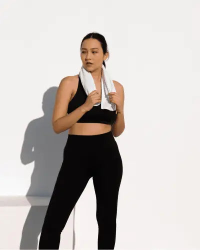 White towel draped around neck highlighting modern activewear trends by RoyalEssenceLux for the modern generation