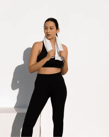 White towel draped around neck highlighting modern activewear trends by RoyalEssenceLux for the modern generation