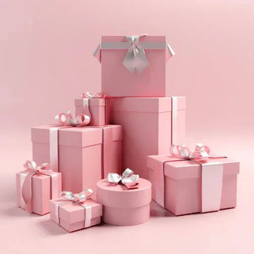 A collection of pink gift boxes with silver ribbons in the royalessencelux gift box collection for gift ideas