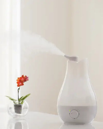 White ceramic humidifier with sleek modern design emitting gentle mist from royalessencelux tech gadgets collection