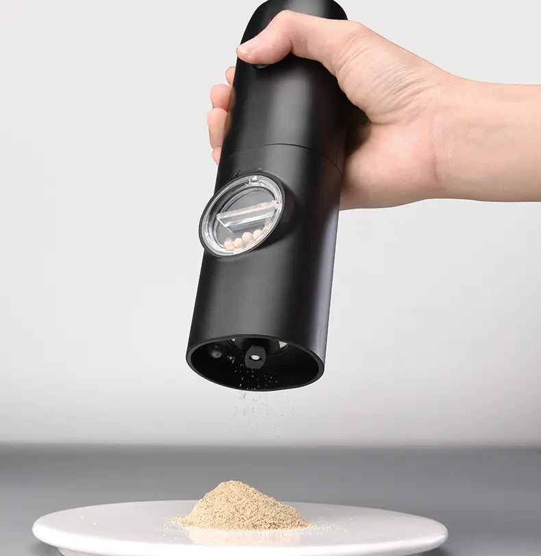 black electric kitchen household pepper grinder with transparent window showing peppercorns inside for kitchen household grinder use