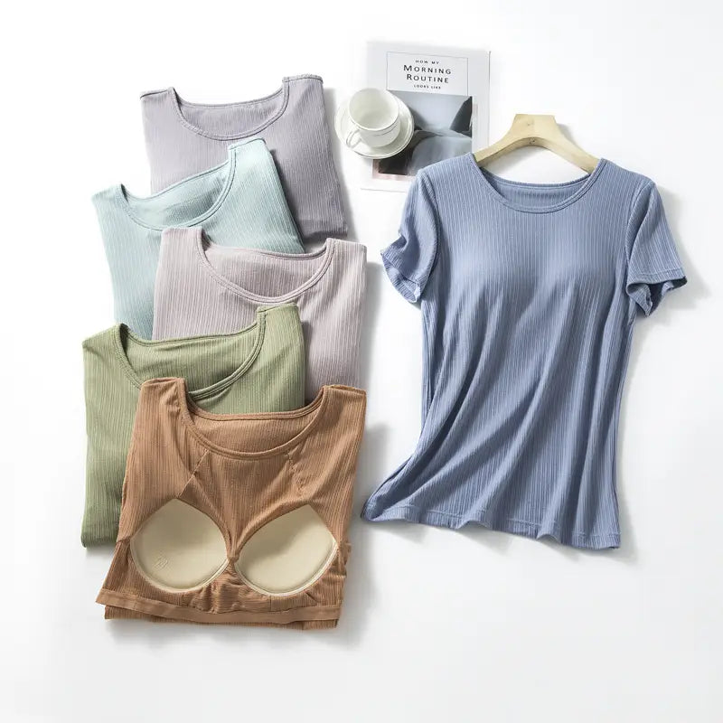 A soft muted blue ribbed knit short-sleeved women’s summerdale loose-fitting padded chest top with a round neckline and subtle vertical texture.