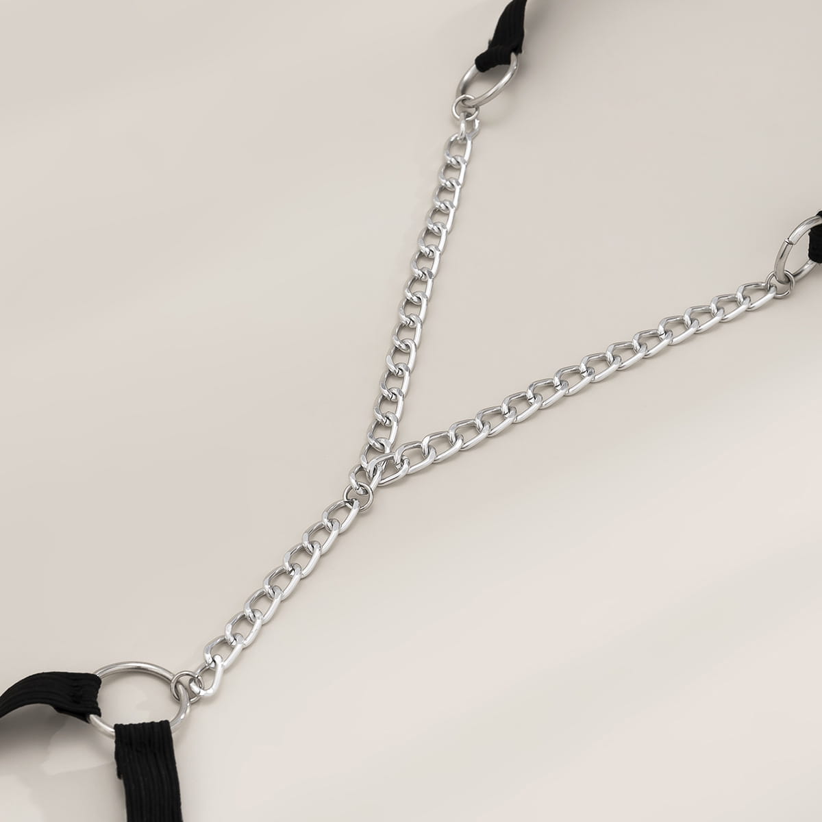 Black elastic geometric body chain thigh garter featuring a silver chain with black fabric straps showcasing simple geometric jewelry design.