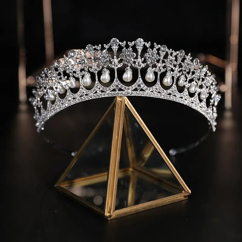 A sparkling silver bridal crown rhinestone featuring intricate crystal and pearl embellishments in a baroque style.