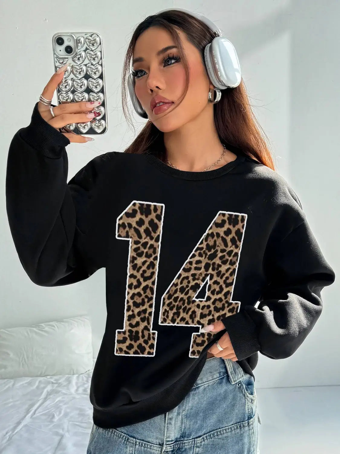 Black crew neck sweatshirt featuring a bold leopard print number 14 on the front for casual wear.