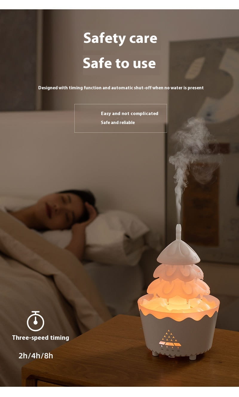 Christmas tree essential oil aroma diffuser humidifier in white and peach tiered cupcake design emitting a soft glow for oil aroma diffusion.