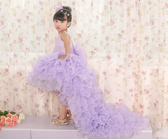 a lavender dress flower girl featuring ruffled lace detailing and a layered voluminous skirt, designed as a fuchsia layered ruffled dress flower girl tuxedo for special occasions.