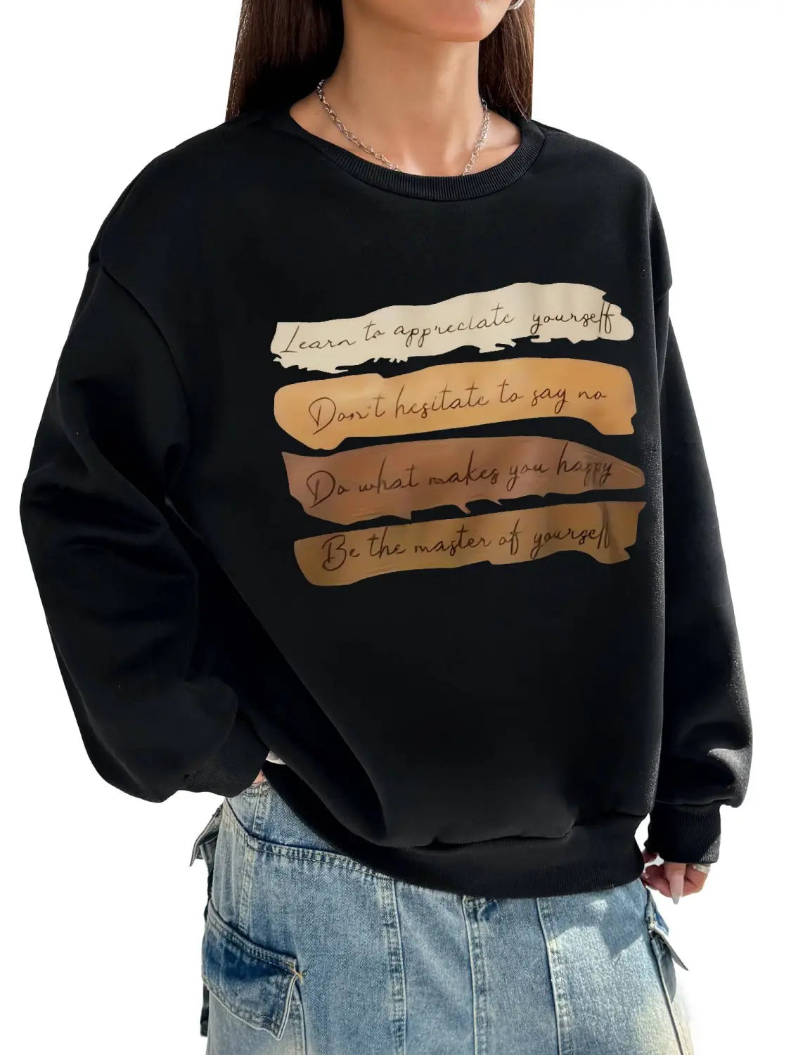 black oversized long sleeve sweatshirt featuring a gold-toned motivational quote in a distressed layered design, ideal for solid colour daily wear.