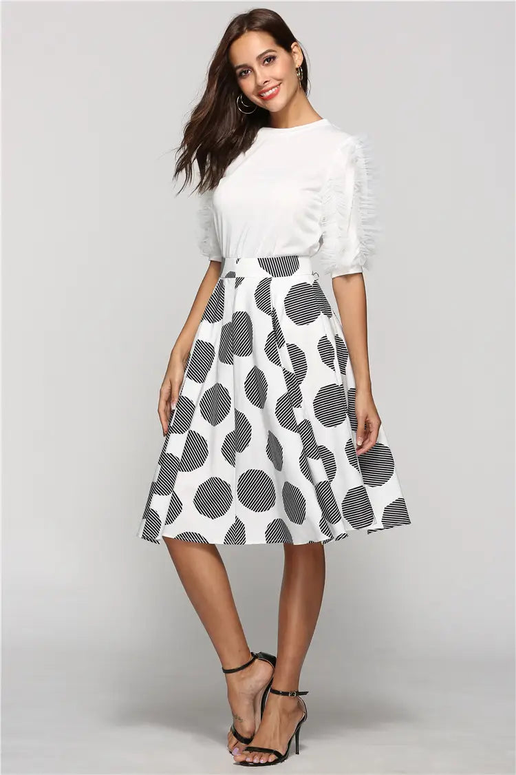white and black large polka dot round slim fit a-line midi skirt with striped circular patterns and lightweight fabric