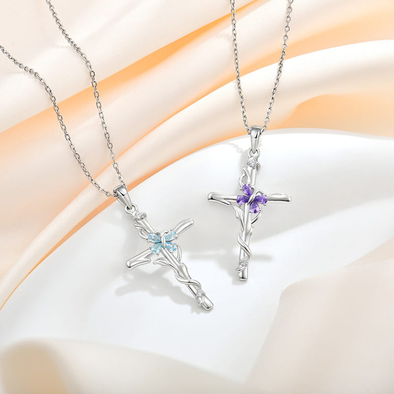 Two silver cross necklaces for sterling silver women featuring one with a light blue gemstone and the other with purple stones as a cross necklace sterling accessory.