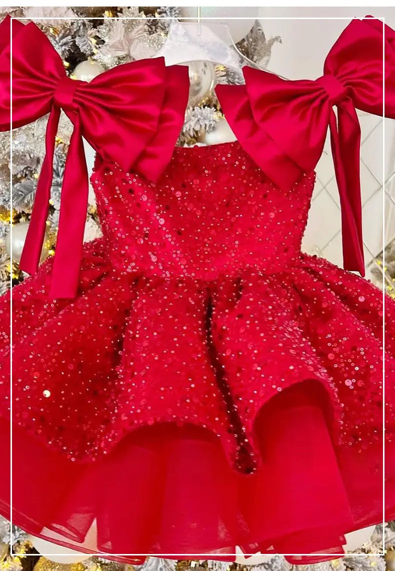 A vibrant princess dress red for toddlers featuring off-the-shoulder satin bows and a layered red tulle tutu skirt.