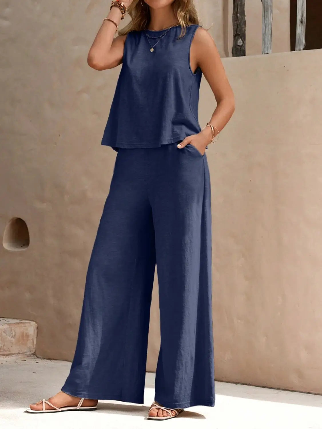 Navy blue sleeveless top with a flared hem paired with matching casual loose navy blue pants suitable for comfortable everyday wear.