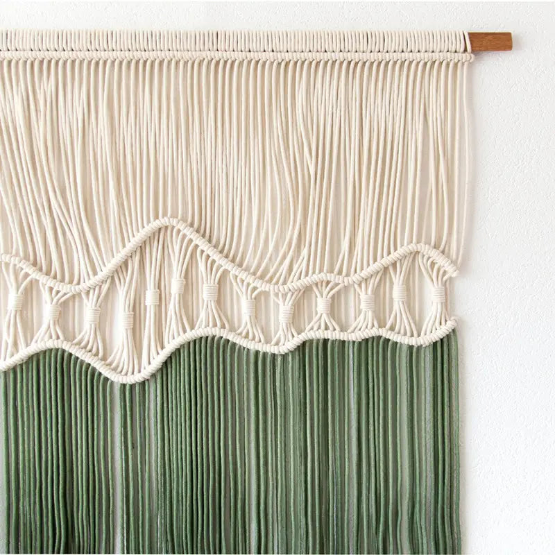 Beige and green tapestry dyeing handmade macrame wall hanging with a wavy textured pattern in sage green and beige colors.