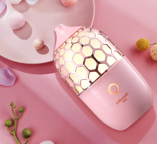 Asakusa pink aroma diffuser featuring a pink honeycomb-patterned aromatherapy lamp with a smooth glossy finish and gold-accented branding.