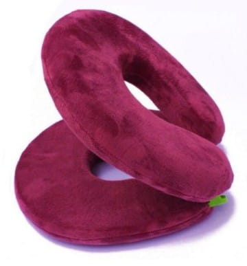 a plush deep burgundy foldable travel pillow with a soft velour texture and a gentle curve designed for comfort in a circular design