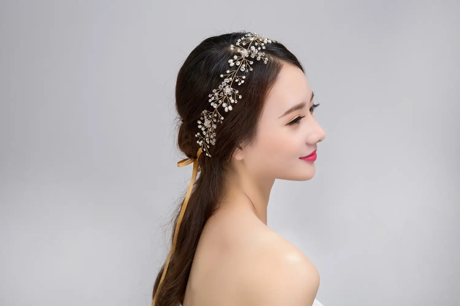 Delicate silver crystal bridal hair accessory with pure handmade gold tone adorned with sparkling crystal and pearl-like embellishments for bridal use.
