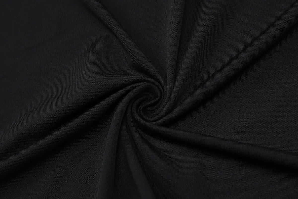 black ribbed knit fabric with a smooth slightly glossy finish featured in a sexy slim oblique shoulder floral mermaid dress with bell sleeve design