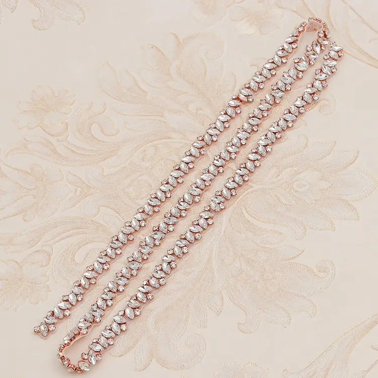 Rose gold-toned rhinestone applique wedding bridal sash featuring clear marquise-cut crystals in a delicate leaf pattern for wedding dress waist jewelry.