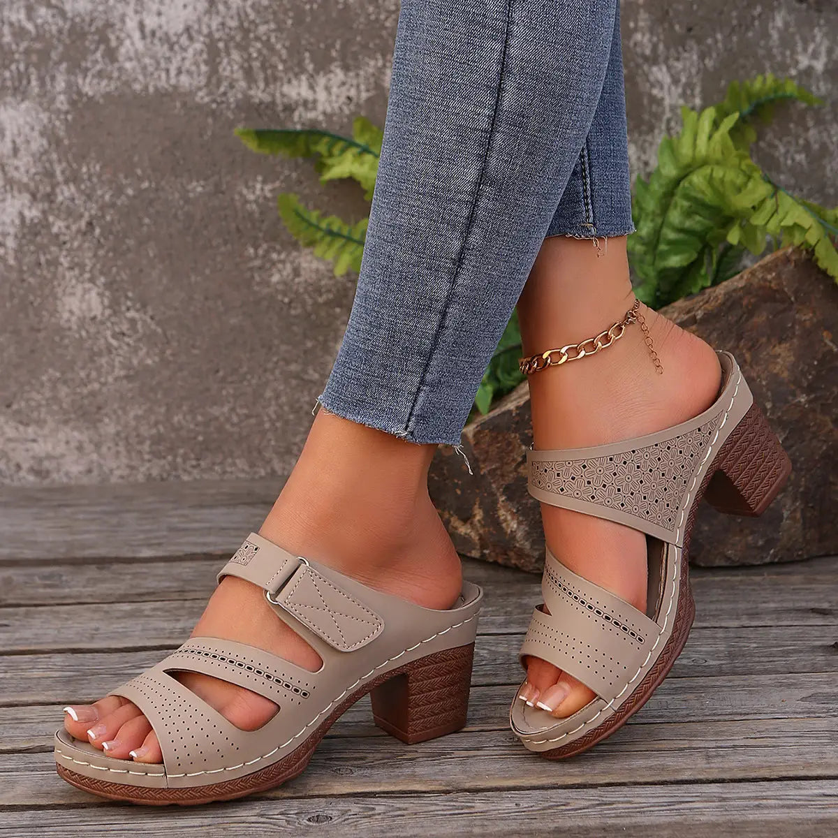 Beige perforated leather mule sandals with a textured brown block heel and stitched detailing ideal for shoes summer casual and summer casual chunky looks.