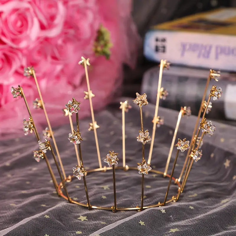 Gold-colored metal tiara adorned with clear and pink crystal star charms showcasing wedding jewelry handmade for brides.
