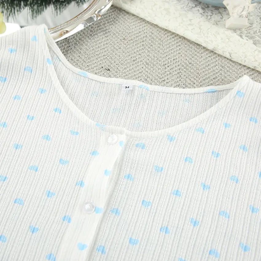 white blouse featuring knitted heart printing with light blue heart-shaped polka dots and a subtle ribbed texture in a comfortable loungewear set