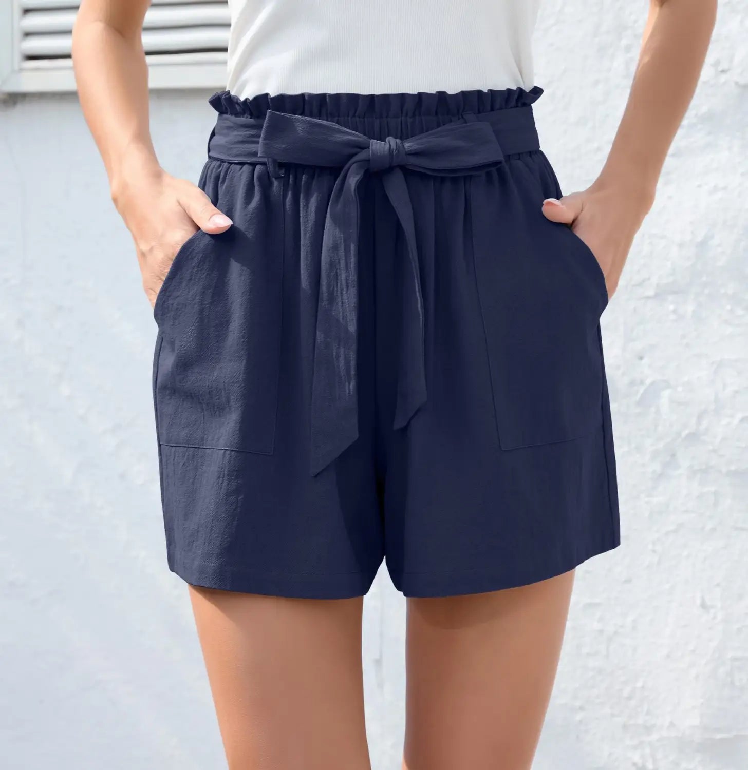 navy blue high-waisted shorts featuring a bow waist tie with side pockets, offering a stylish fashion ruffle bow waist look.