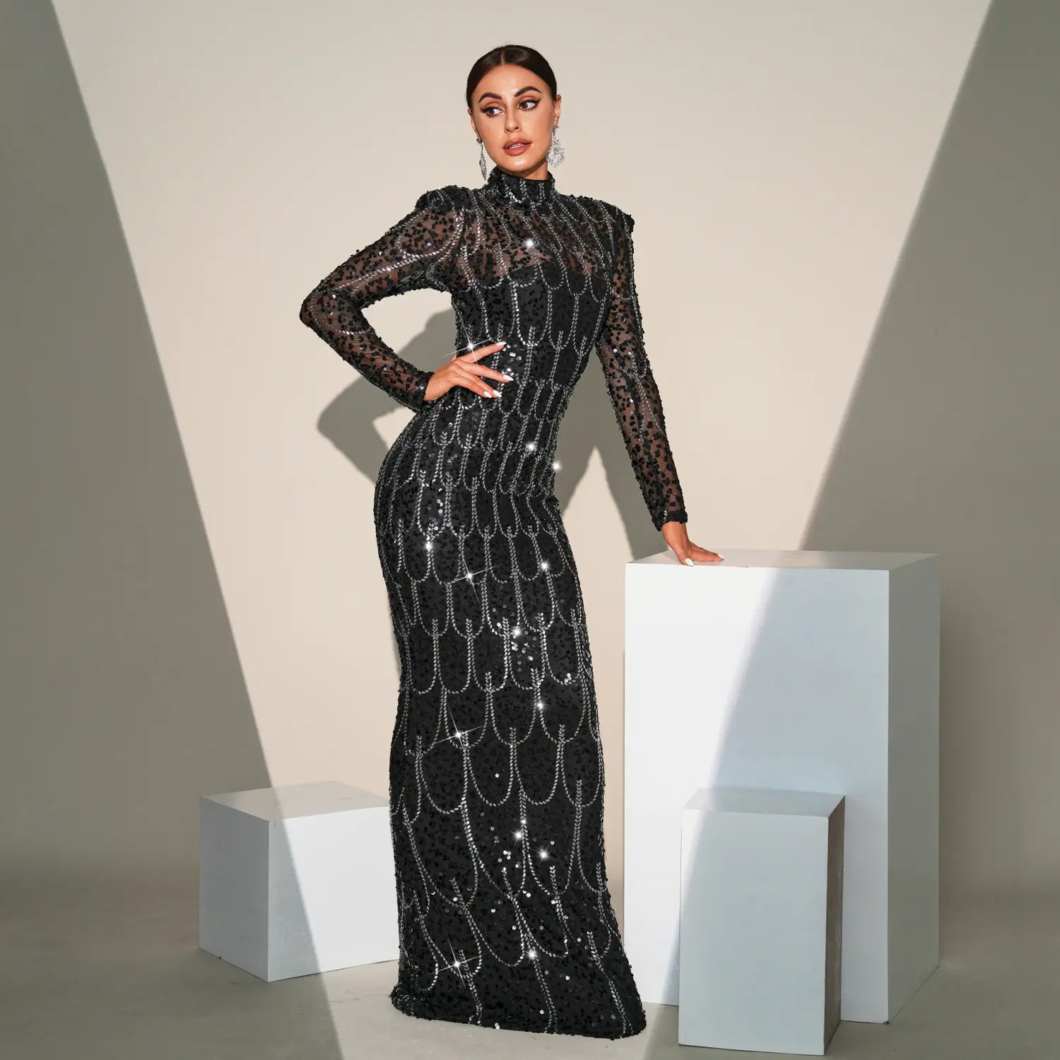 Black sequined long sleeve round neck evening dress featuring intricate silver sequin patterns on a black fabric designed for banquet evening occasions.