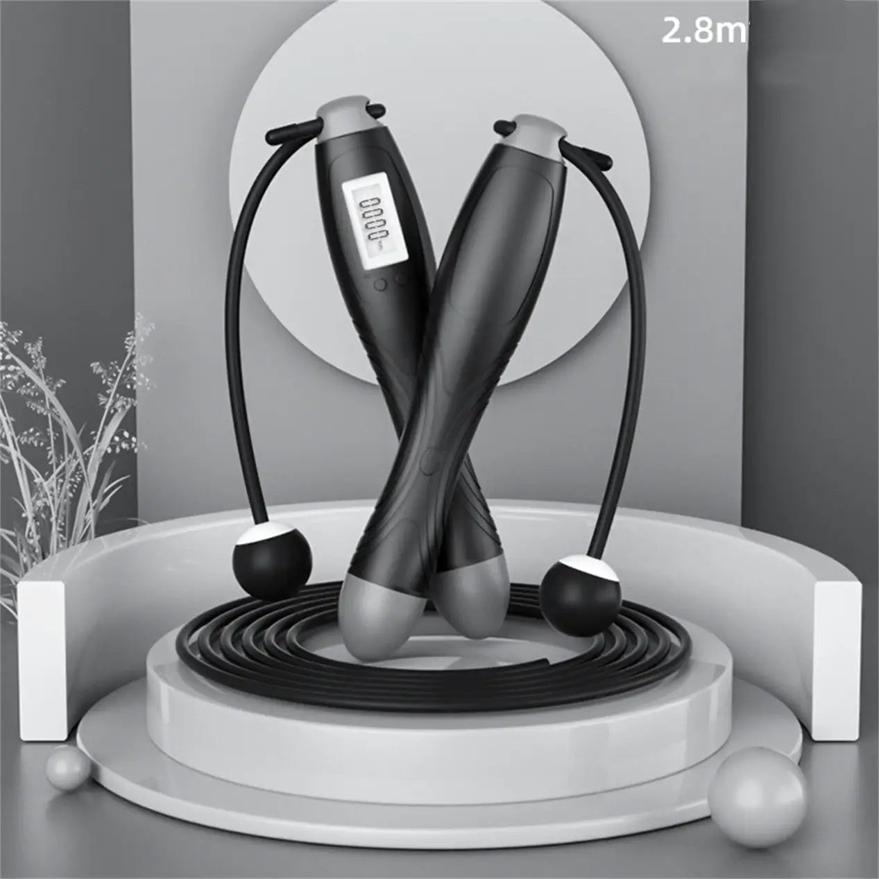 Black and gray cordless electronic skipping rope with 2.8 meter length and lcd display on handle for tracking metrics.