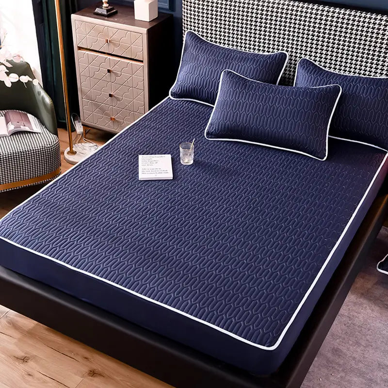 Navy blue quilted thickened all-inclusive dust-proof single-piece fitted sheet with white piping edges designed for comprehensive dust protection.