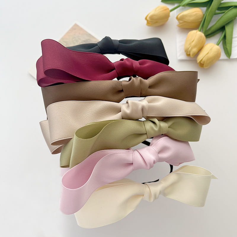 a collection of french satin bow headbands for women featuring satin bow headbands in soft pastel and earthy tones with neatly tied bow designs.