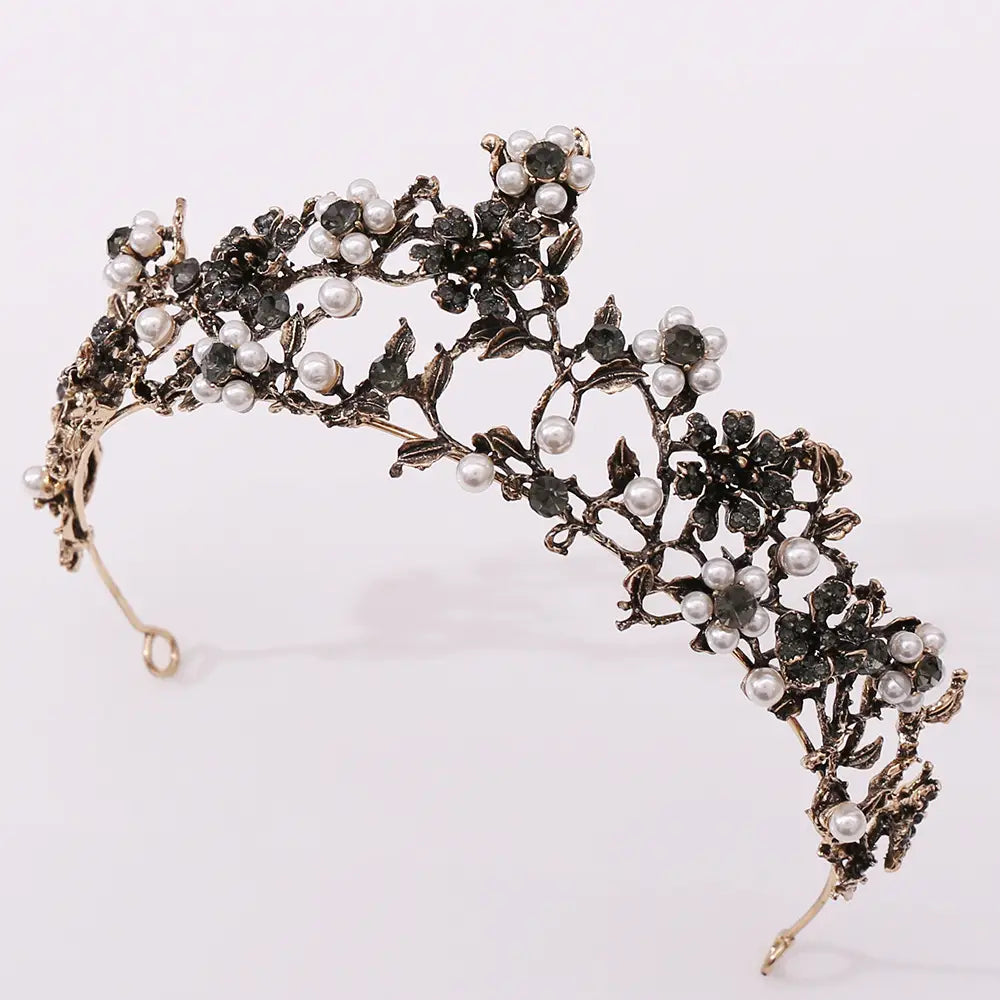 an ornate vintage-style floral black diamond pearl baroque bridal crown featuring intricate black and silver floral designs adorned with white pearls