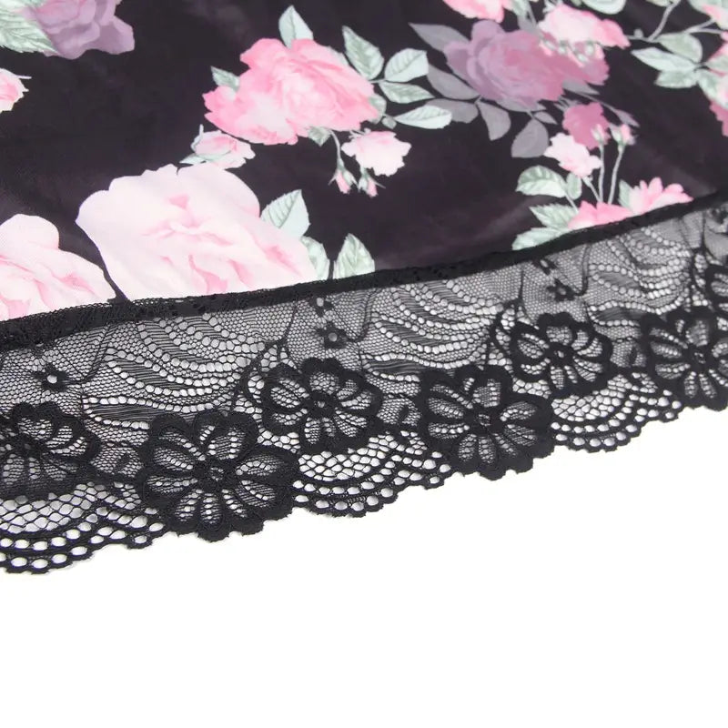 plus size embroidery patchwork lace sleeping dress featuring black lace trim with intricate floral patterns bordering dark fabric with pink roses and green leaves
