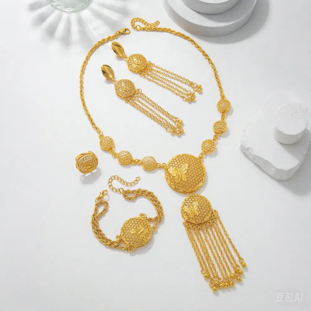 Gorgeous butterfly middle ring set wedding decoration necklace featuring a golden filigree design with intricate circular motifs and dangling chain tassels.