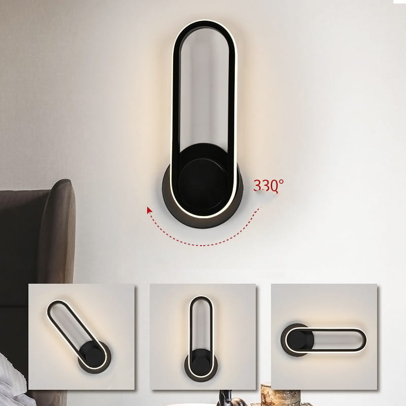 Modern white oval bedside bedroom wall lamp featuring a sleek elongated oval design in black and silver as a stylish bedroom wall lamp.