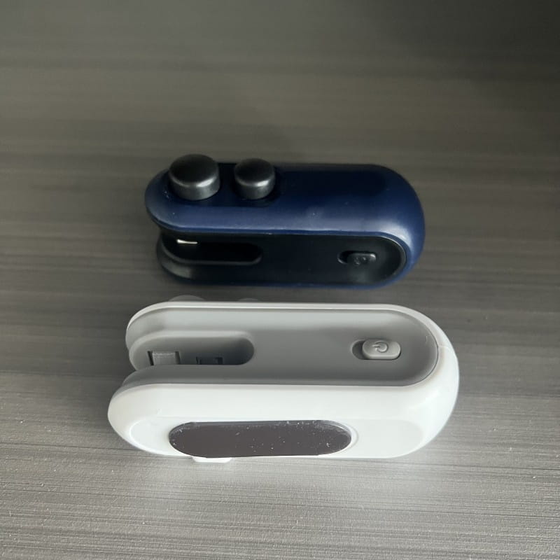 blue and white magnetic phone clip holders with metallic buttons designed for portable usb heat sealer and vacuum sealer storage and organization.