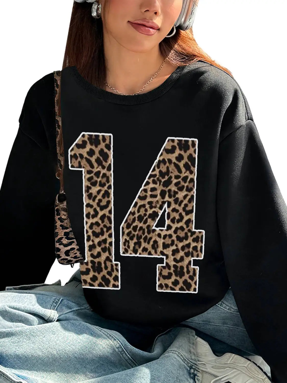 black crew neck sweatshirt featuring a bold leopard-print number 14 on the front