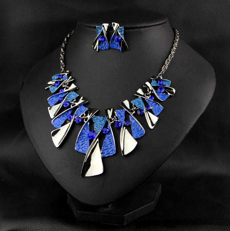 Blue and silver metal geometric shape necklace featuring textured blue enamel pieces and accent rhinestones from a geometric shape rhinestone earring necklace set.