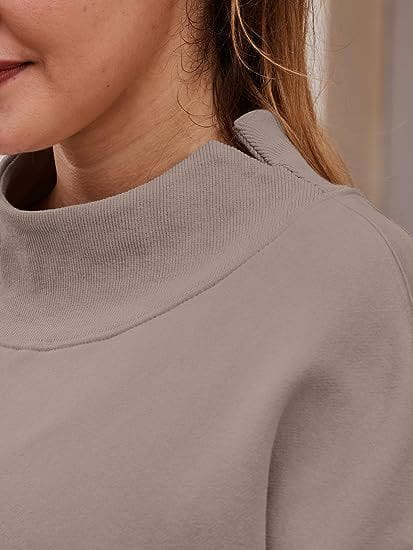 a soft muted gray ribbed knit sweater with a high collar featured as a pullover sweatshirt solid color garment