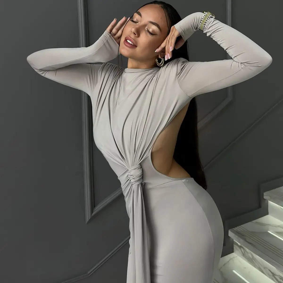 A sleek gray long sleeve dress with a distinctive back knot detail designed for a sexy hot girl look.