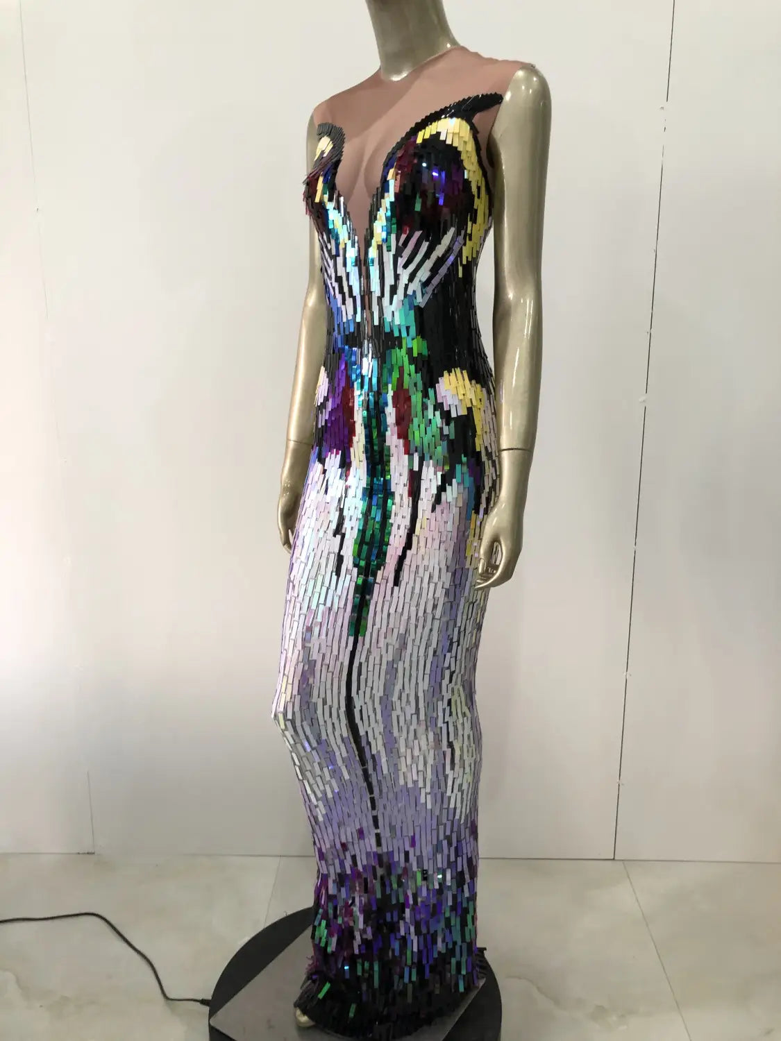 A shimmering rainbow gradient sequin evening dress female singer costume with iridescent sequins forming a vibrant butterfly design across the bodice and skirt.