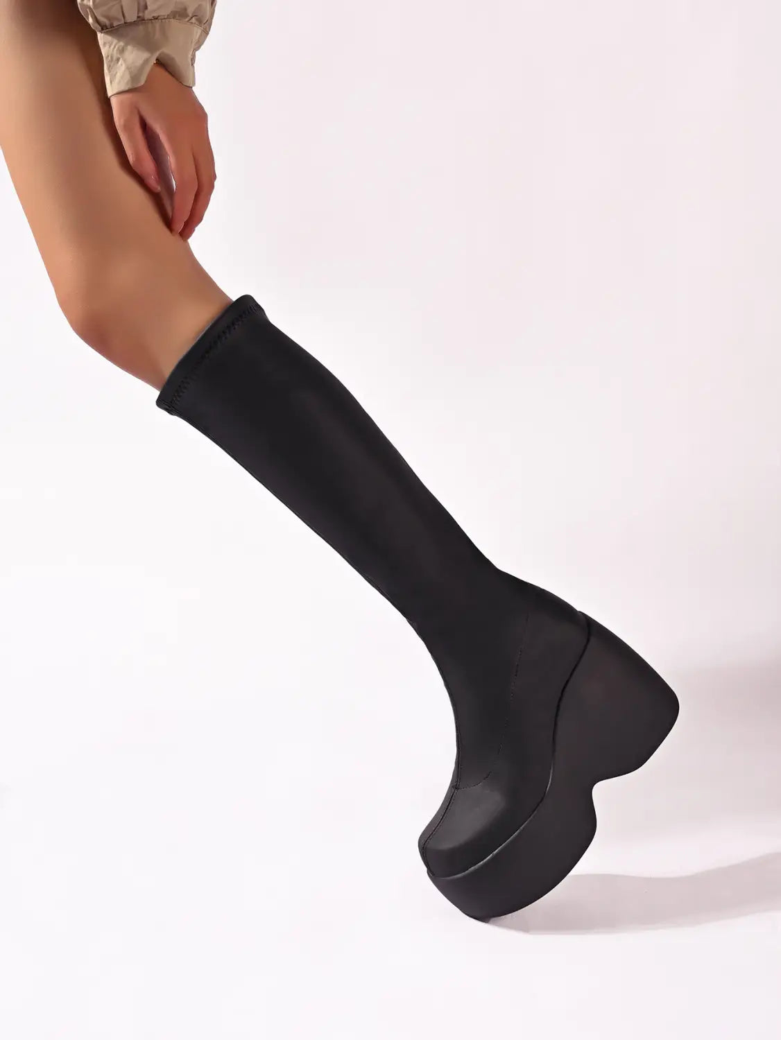black platform knee high elastic leather boots with a sleek stretchy upper and a thick block heel perfect for stylish wear