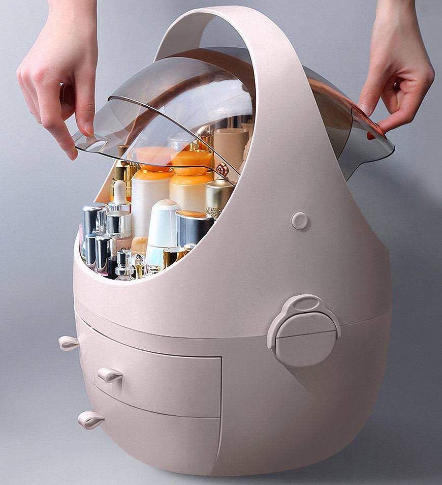Beige oval-shaped makeup organizer with transparent dome lid and two front drawers designed for cosmetic storage with a waterproof dust proof lid.