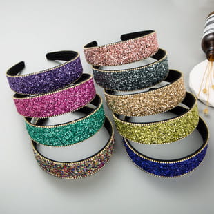 a collection of baroque vintage court style crystal headbands featuring glittery and sparkly designs in vibrant purple pink teal gold and blue colors