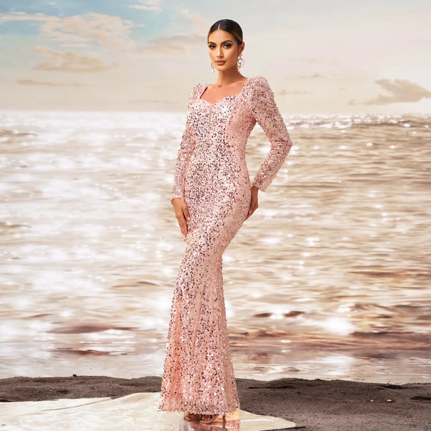 a shimmering pink long sleeve sequined sheath fishtail evening dress with a square neckline and elegant mermaid silhouette