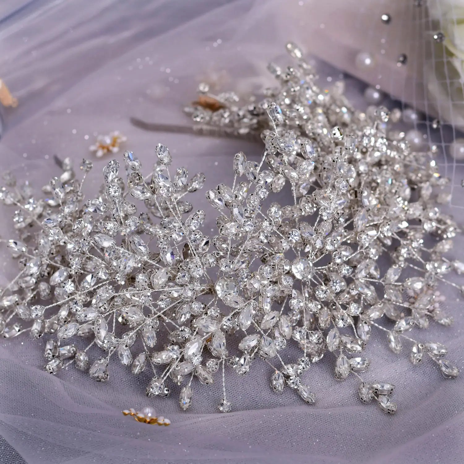 A sparkling silver crystal heavy handmade rhinestone bridal hair accessory designed with intricate leaf and branch patterns for a snow queen wedding.