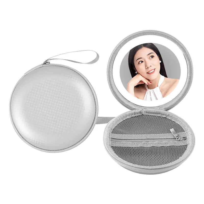 silver circular travel mirror case with mesh interior and zipper featuring an integrated handle in a round bag blue design